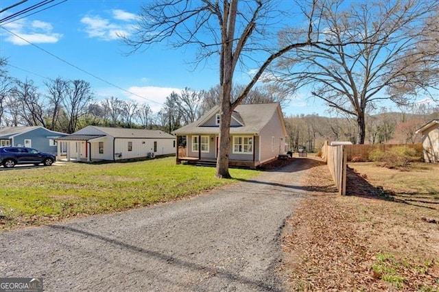 bungalow-style house with driveway and a front lawn