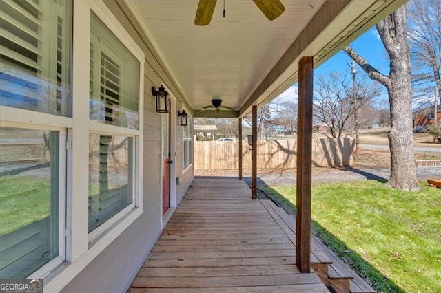 deck with ceiling fan and fence