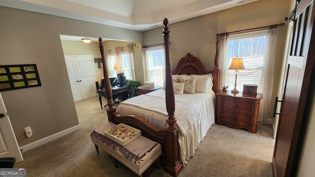 bedroom with light carpet and baseboards