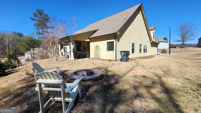 back of property featuring an outdoor fire pit