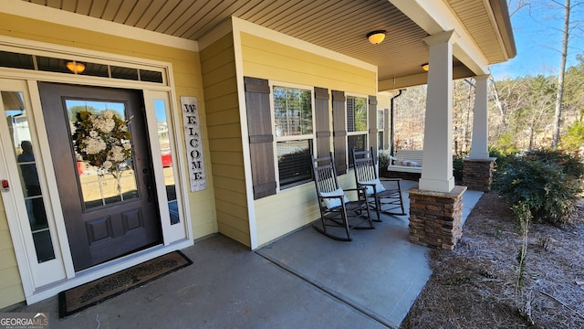 doorway to property with covered porch