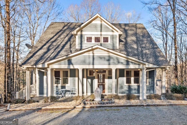 view of front of property featuring a shingled roof and covered porch