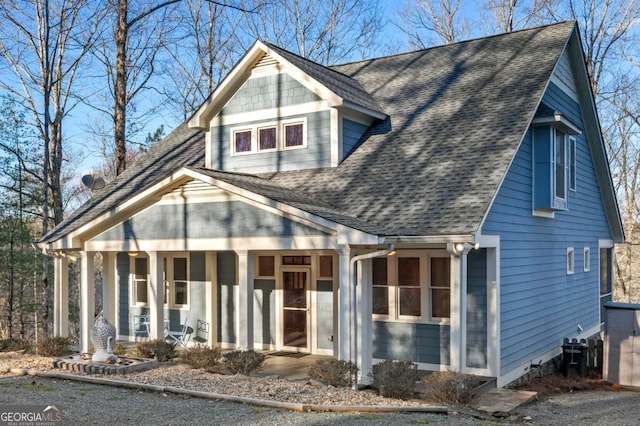 view of front of house featuring a shingled roof and covered porch