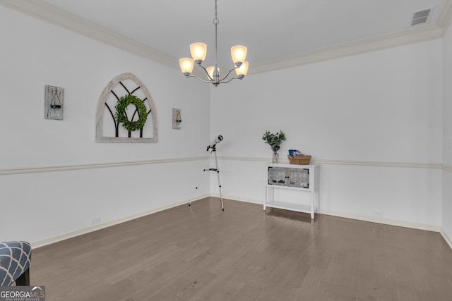 unfurnished dining area featuring ornamental molding, wood finished floors, visible vents, and baseboards