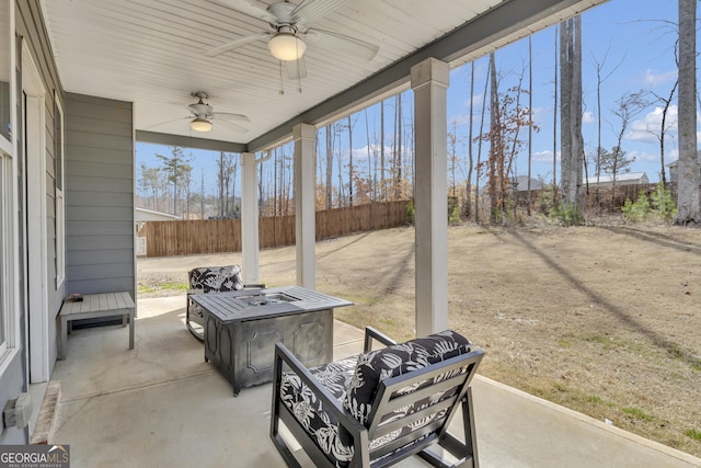 view of patio featuring fence and ceiling fan