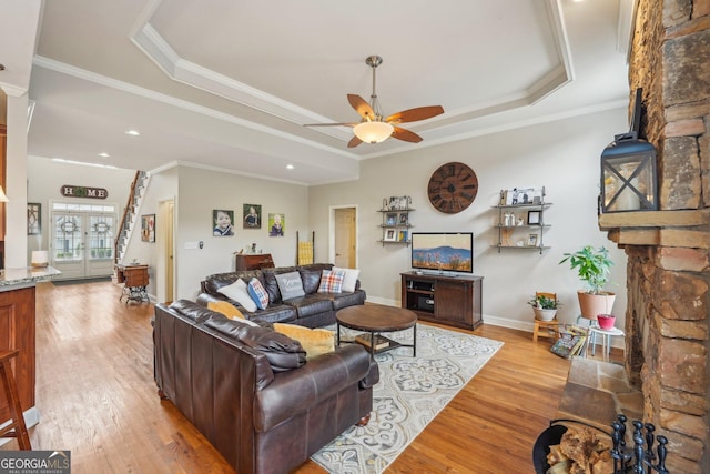 4740 Arbor Meadows Dr, Cumming, GA 30040 - living room with light wood-type flooring, baseboards, a tray ceiling, and crown molding