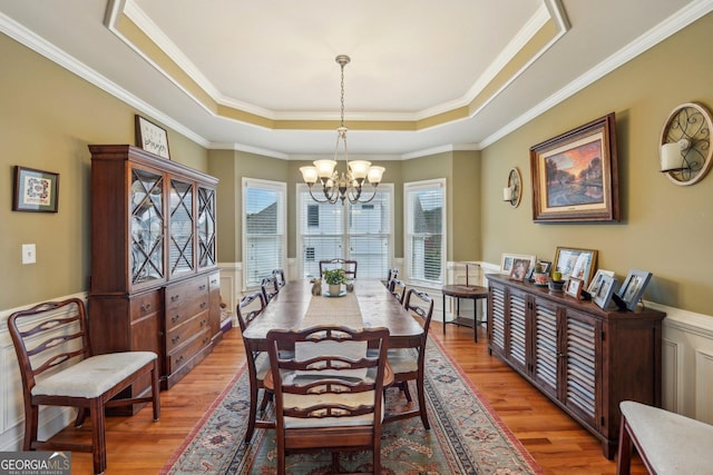 4740 Arbor Meadows Dr, Cumming, GA 30040 - dining area with a wainscoted wall, light wood-style flooring, a raised ceiling, and a notable chandelier