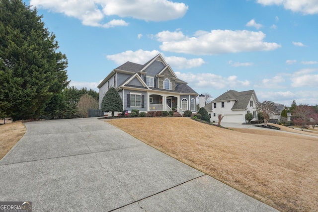 view of front facade with a front lawn and a porch