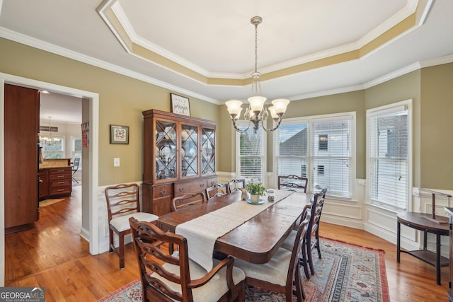 4740 Arbor Meadows Dr, Cumming, GA 30040 - dining space with a wealth of natural light, a raised ceiling, light wood-style flooring, and an inviting chandelier