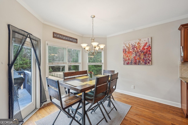 4740 Arbor Meadows Dr, Cumming, GA 30040 - dining area with light wood-style flooring, baseboards, a notable chandelier, and ornamental molding