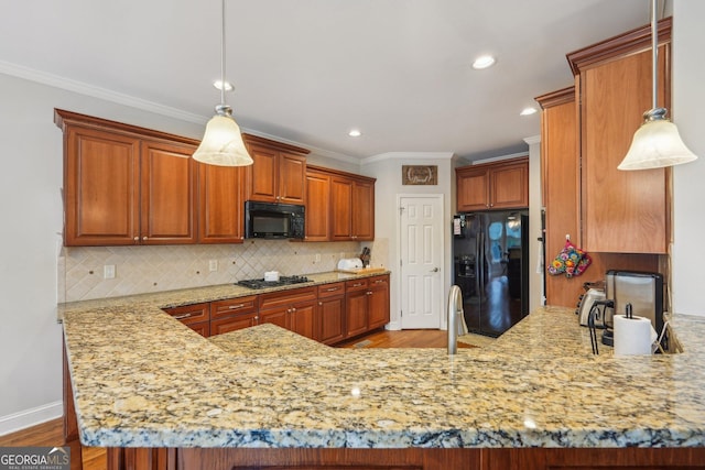 4740 Arbor Meadows Dr, Cumming, GA 30040 - kitchen featuring light stone counters, a peninsula, black appliances, tasteful backsplash, and crown molding