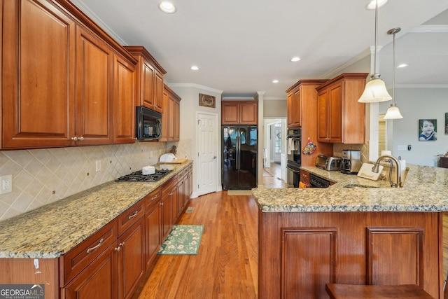 4740 Arbor Meadows Dr, Cumming, GA 30040 - kitchen with a peninsula, black appliances, crown molding, and a sink