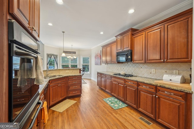 4740 Arbor Meadows Dr, Cumming, GA 30040 - kitchen featuring visible vents, a peninsula, crown molding, black appliances, and a sink