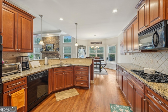 4740 Arbor Meadows Dr, Cumming, GA 30040 - kitchen with a toaster, light wood-style floors, a peninsula, black appliances, and a sink