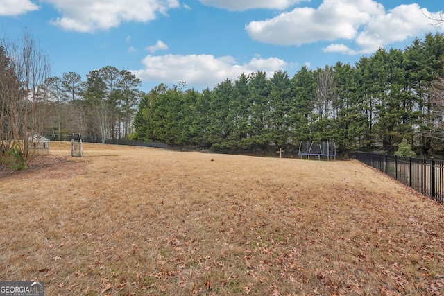 4740 Arbor Meadows Dr, Cumming, GA 30040 - view of yard featuring a trampoline and fence
