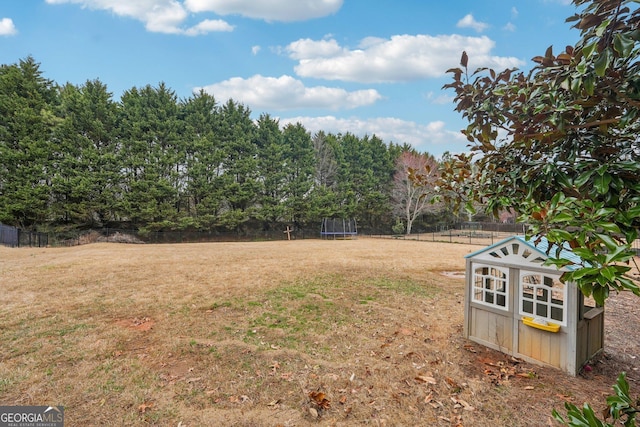 4740 Arbor Meadows Dr, Cumming, GA 30040 - view of yard with a trampoline and fence