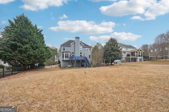 4740 Arbor Meadows Dr, Cumming, GA 30040 - rear view of house featuring fence, a lawn, a wooden deck, and stairs