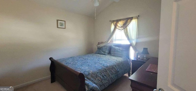 bedroom featuring a ceiling fan, vaulted ceiling, and baseboards