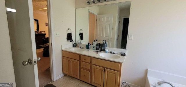 bathroom featuring a washtub, double vanity, a sink, and tile patterned floors