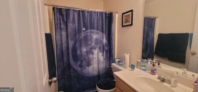 bathroom with toilet, curtained shower, and vanity