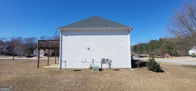 view of side of property with a deck and a yard