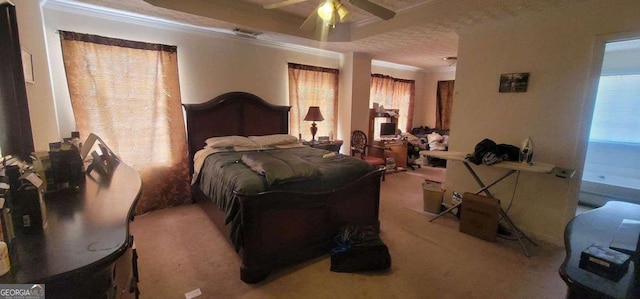 carpeted bedroom featuring ornamental molding and ceiling fan