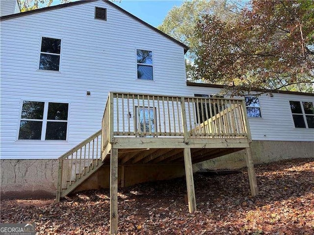 rear view of house with a deck and stairs