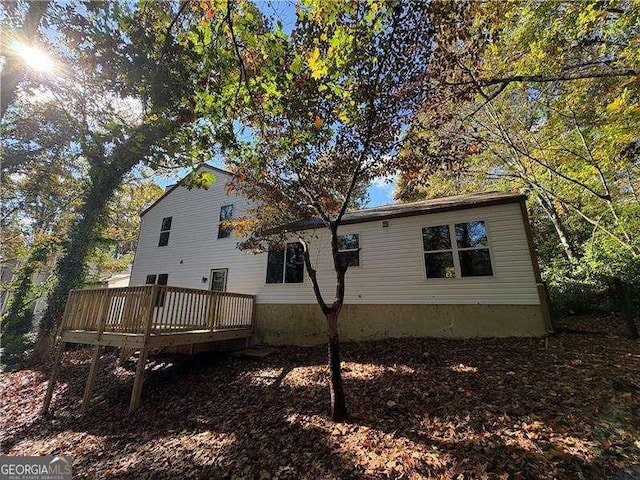 back of property with a wooden deck