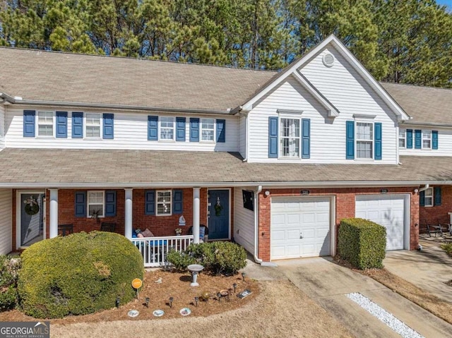 view of front of property with brick siding, a porch, a shingled roof, concrete driveway, and an attached garage