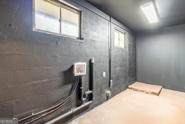 below grade area featuring concrete block wall and a wealth of natural light