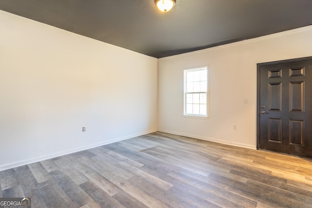 foyer entrance with baseboards and wood finished floors