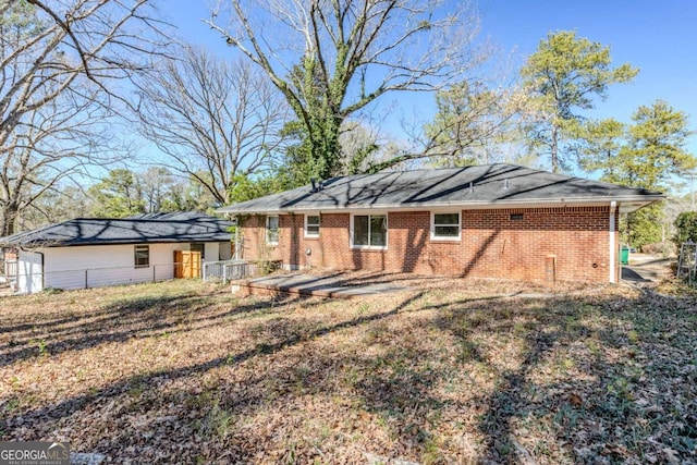 view of front of house with brick siding and fence