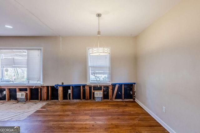 interior space with wood finished floors and baseboards