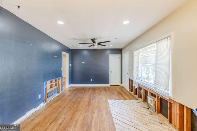 unfurnished living room with ceiling fan, baseboards, wood finished floors, and recessed lighting