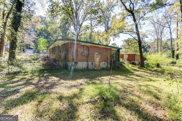 view of side of home with brick siding