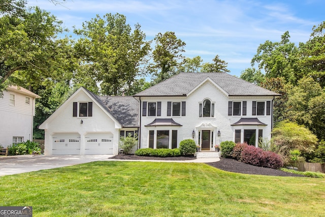 colonial house featuring driveway, brick siding, and a front yard