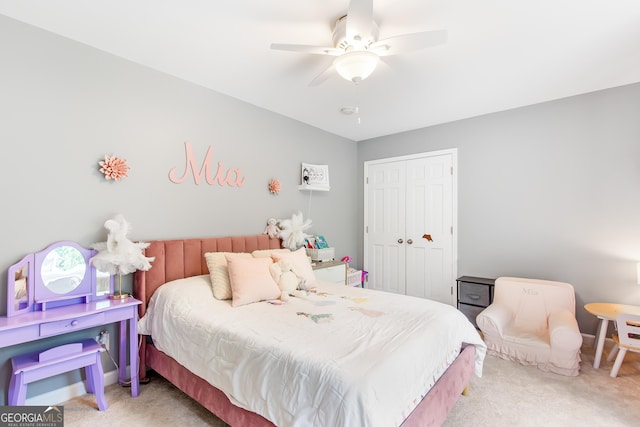 bedroom featuring light carpet, a closet, and a ceiling fan