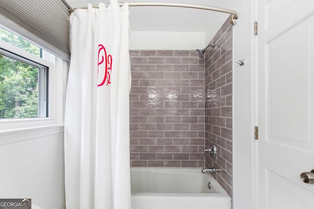 bathroom featuring shower / bath combo with shower curtain