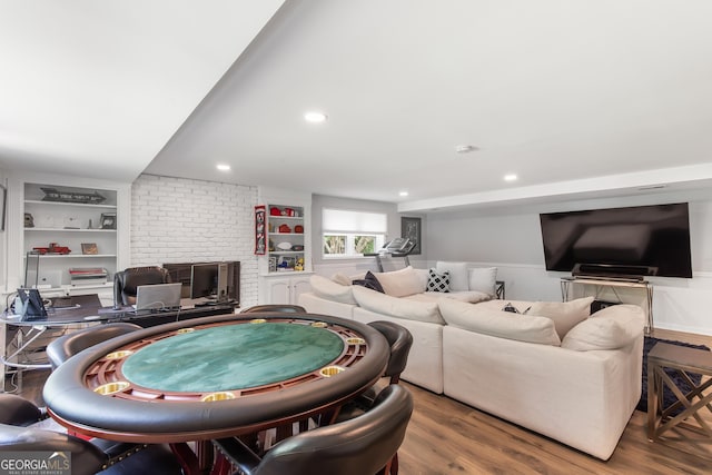 living area with recessed lighting, wood finished floors, and built in features