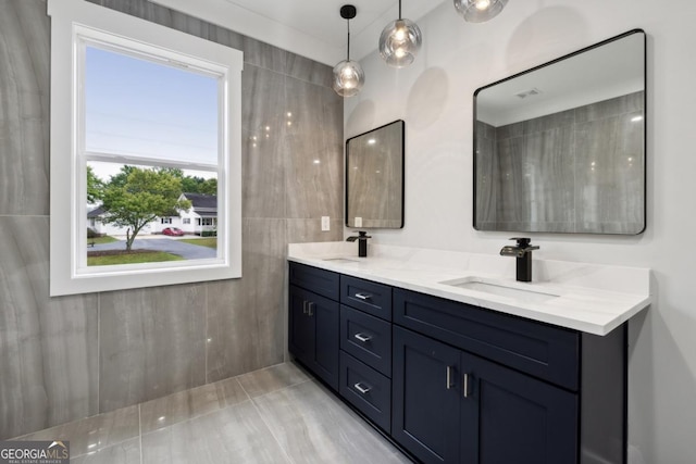 bathroom featuring a sink and double vanity