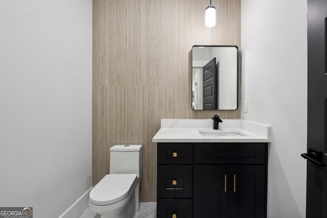 bathroom featuring vanity and toilet