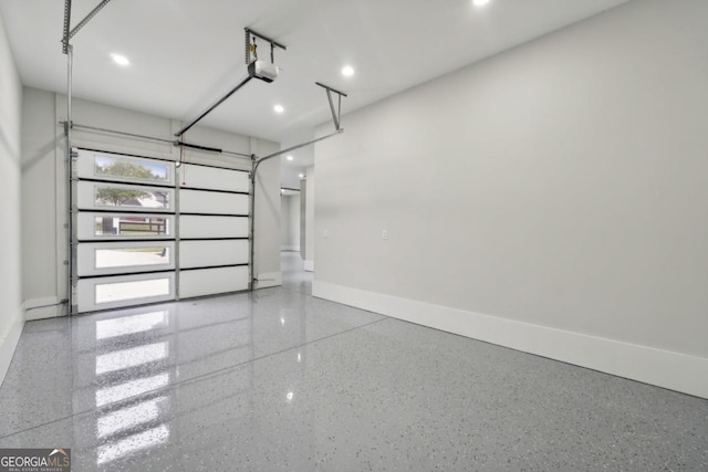 garage featuring a garage door opener and baseboards