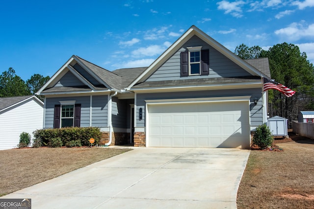 view of front of property with stone siding, driveway, and a garage