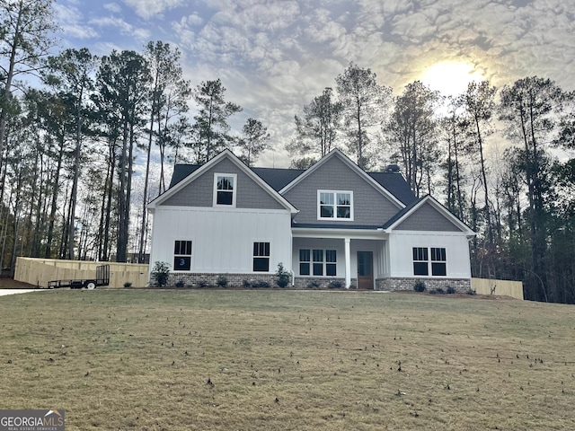 craftsman-style house with a front lawn and board and batten siding