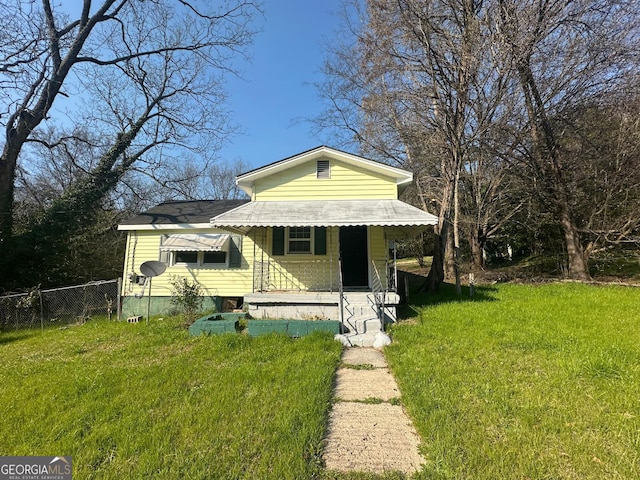 bungalow-style house featuring fence and a front yard