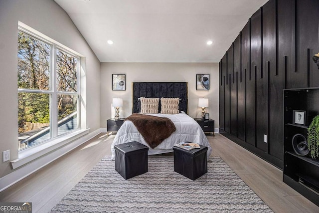 bedroom featuring light wood-style floors, baseboards, vaulted ceiling, and recessed lighting