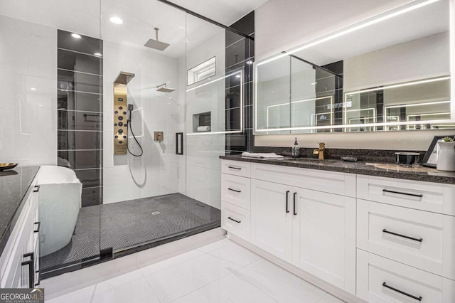 bathroom with a tile shower, a freestanding bath, and vanity