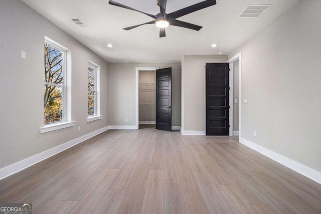 unfurnished bedroom featuring visible vents, baseboards, and wood finished floors