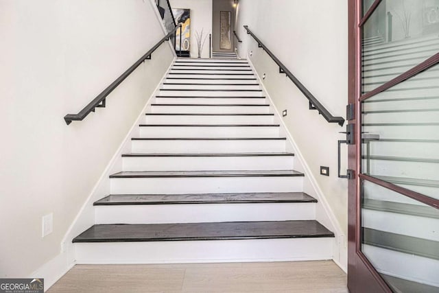 stairs with wood finished floors