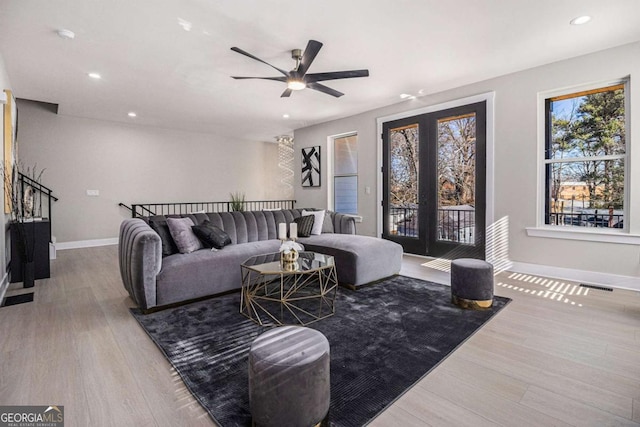 living room with baseboards, visible vents, wood finished floors, and recessed lighting